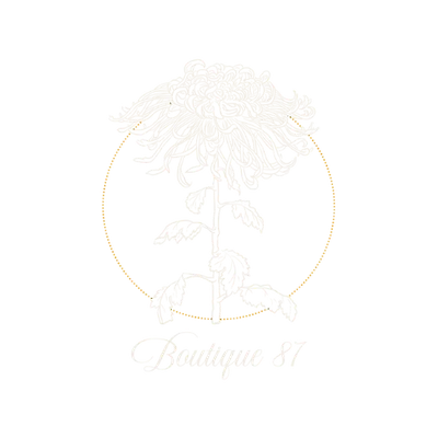 Boutique 87: a chrysanthemum drawn in fine line inside a gold ring